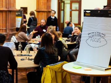 Conference room full of people with flip chart with the word focus