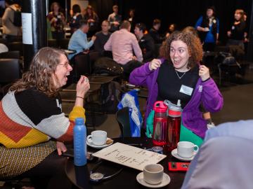 people sat round tables at a meeting