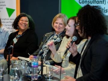 A group of 5 women sitting down chatting