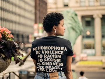 Woman sat outside with edi relevant words printed on her tshirt