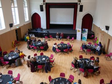 delegates at Hynt Symposium sitting round tables