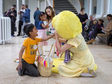 photo of a child touching a performer in costume