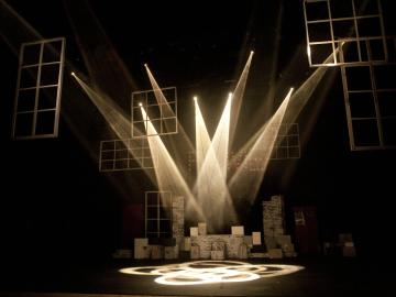 Image of a set on stage with stage light shining down on the set