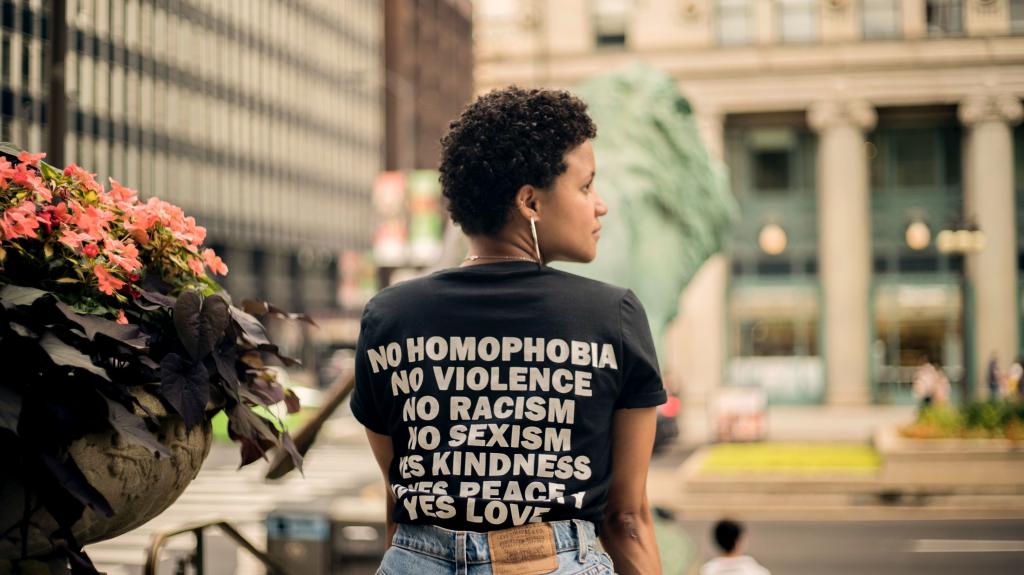 Woman sat outside with edi relevant words printed on her tshirt