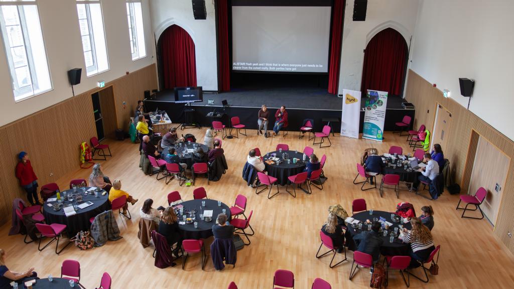 delegates at Hynt Symposium sitting round tables