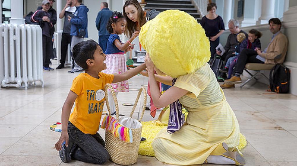 photo of a child touching a performer in costume