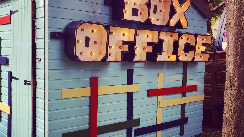 Blue and white striped shed with the words Box Office on it.