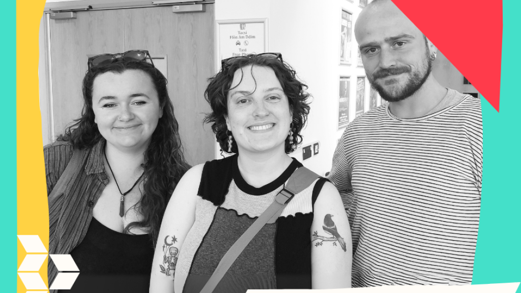 2 women and 1 man standing