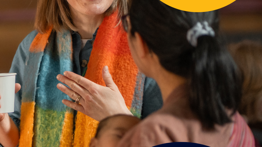 2 women having a chat with the one woman with baby in arms