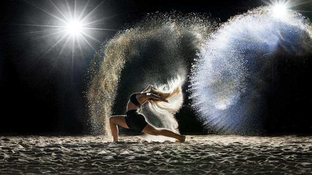 Dancer performing in the dark with shimmering lights